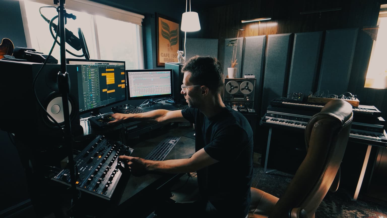 Chris Bartels working at a mixing console in his studio.
